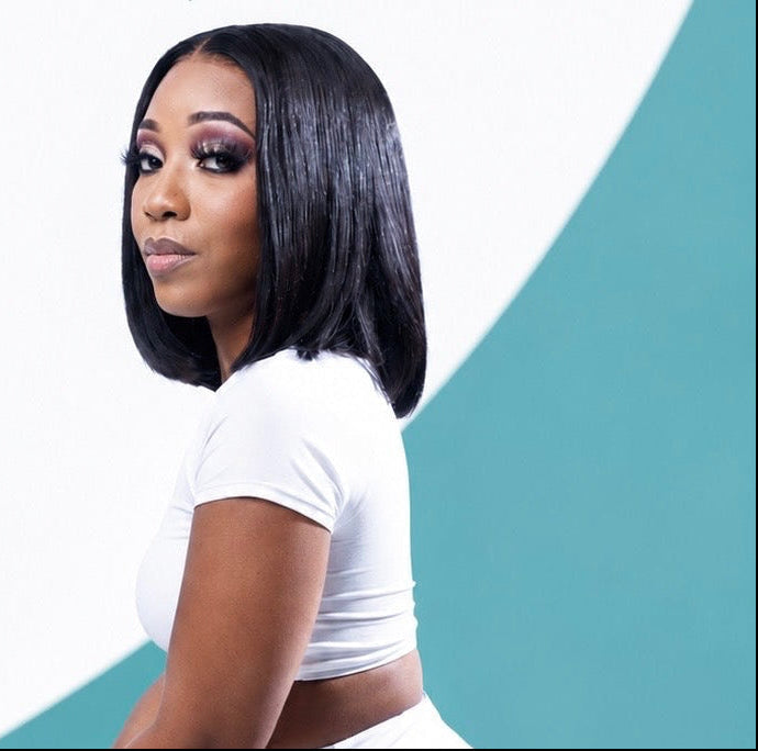 Woman with styled hair against a white and teal background